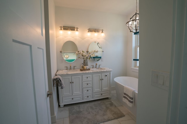 bathroom featuring a tub, vanity, and a notable chandelier