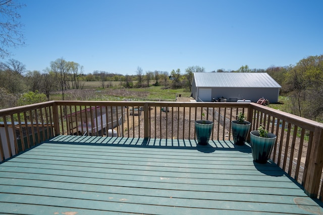 wooden terrace with a garage and an outdoor structure