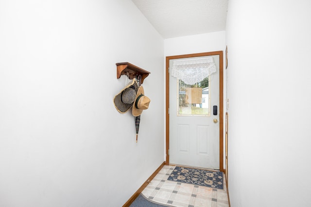 doorway featuring a textured ceiling