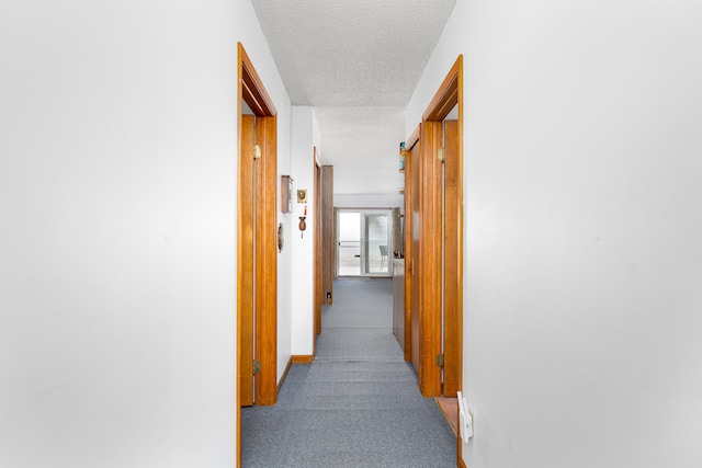 hall with a textured ceiling