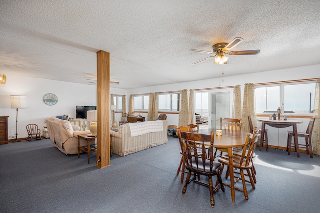 carpeted dining room with ceiling fan, plenty of natural light, and a textured ceiling