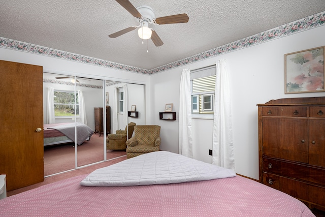 bedroom featuring carpet, ceiling fan, a textured ceiling, and a closet