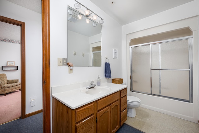 full bathroom featuring vanity, enclosed tub / shower combo, and toilet