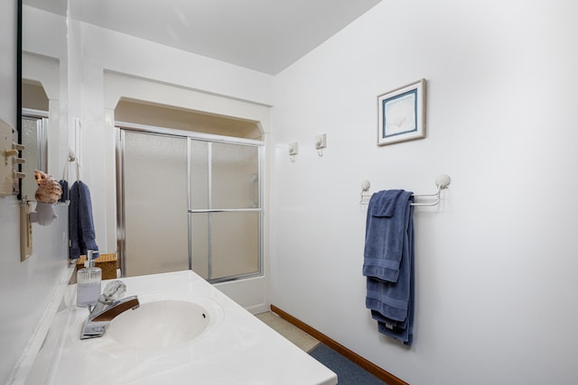 bathroom with vanity and shower / bath combination with glass door