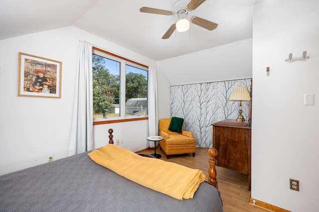 bedroom with vaulted ceiling, light hardwood / wood-style flooring, and ceiling fan