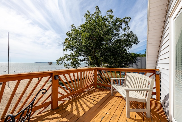 wooden terrace featuring a water view