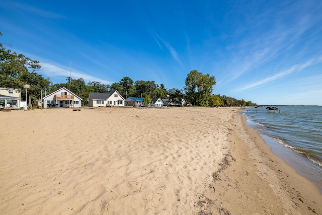 view of yard featuring a beach view and a water view
