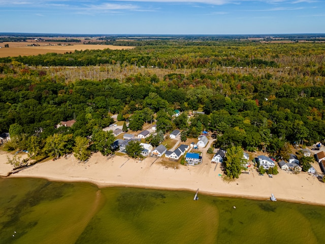bird's eye view featuring a water view and a beach view