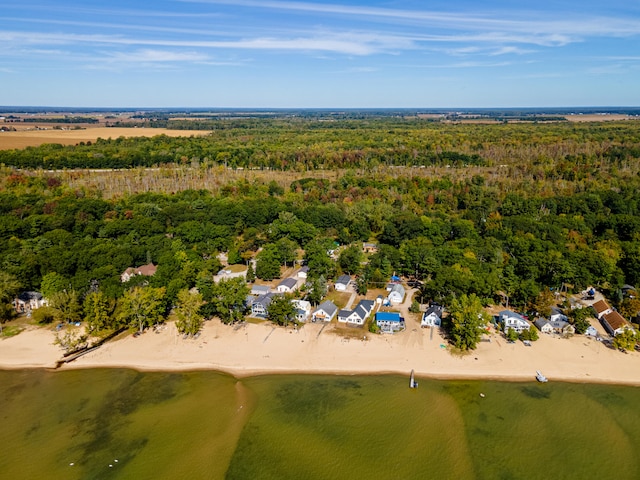 birds eye view of property with a view of the beach and a water view