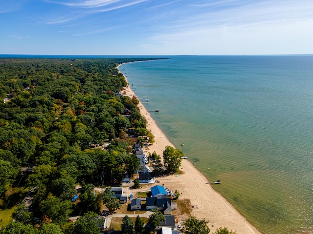 bird's eye view featuring a water view and a beach view