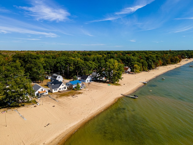 birds eye view of property featuring a beach view and a water view