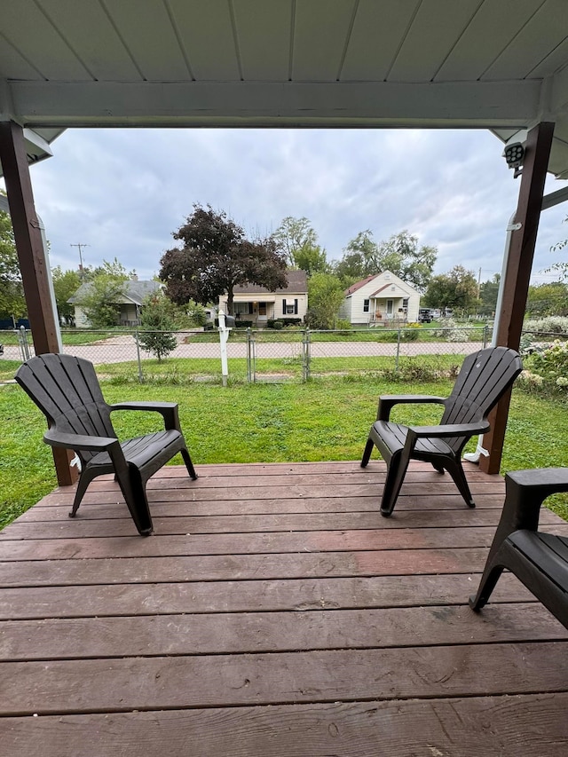 wooden deck featuring a lawn