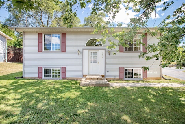 split foyer home featuring a front lawn