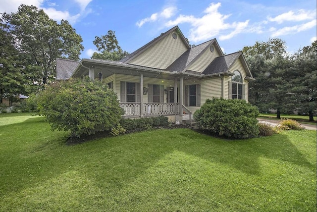 view of side of home with a yard and a porch