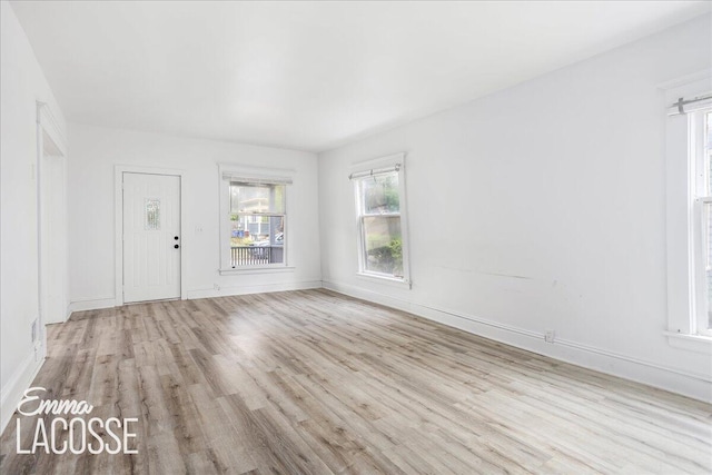 318 Diamond Ave SE, Grand Rapids, MI 49506 - unfurnished living room with wood finished floors and baseboards