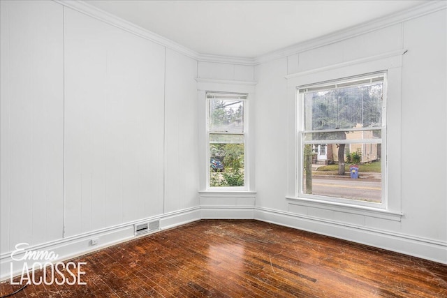 318 Diamond Ave SE, Grand Rapids, MI 49506 - empty room featuring dark wood finished floors and ornamental molding