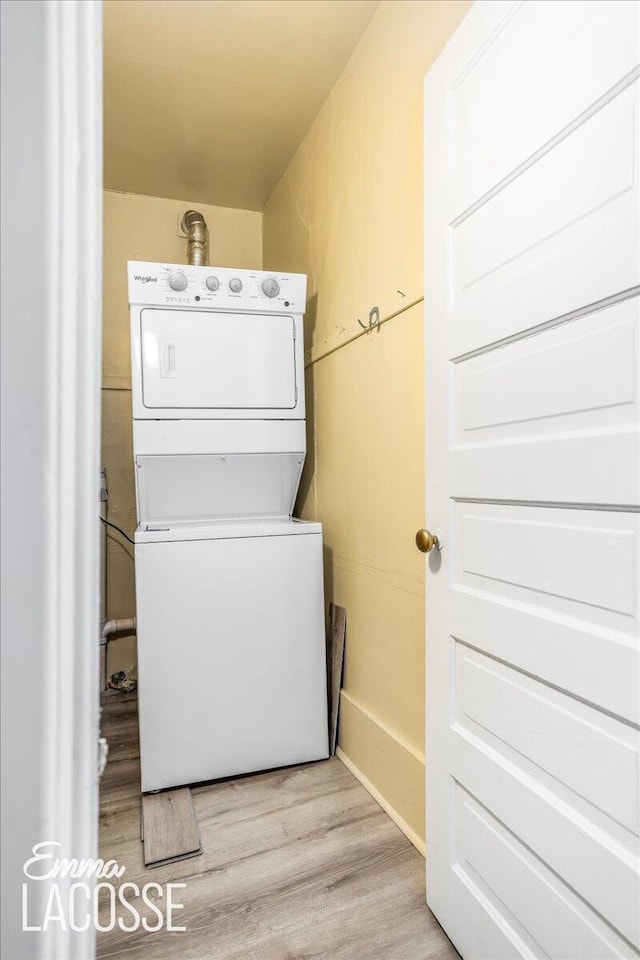 318 Diamond Ave SE, Grand Rapids, MI 49506 - laundry area featuring estacked washer and dryer and wood finished floors