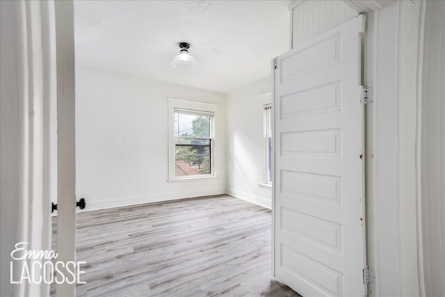 318 Diamond Ave SE, Grand Rapids, MI 49506 - unfurnished bedroom with wood finished floors and baseboards