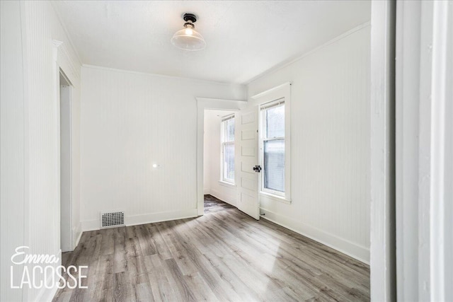 318 Diamond Ave SE, Grand Rapids, MI 49506 - unfurnished room featuring wood finished floors, ornamental molding, and baseboards