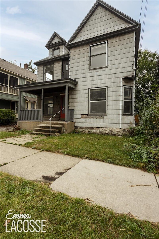 rear view of property featuring a lawn