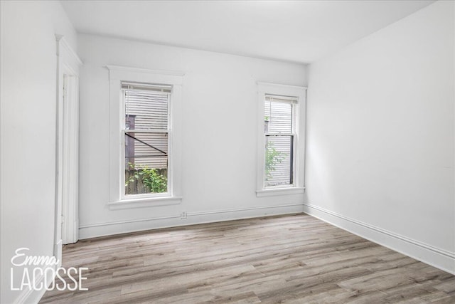 318 Diamond Ave SE, Grand Rapids, MI 49506 - unfurnished room featuring wood finished floors and baseboards