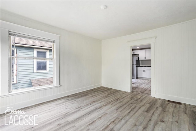 318 Diamond Ave SE, Grand Rapids, MI 49506 - empty room with light wood-style flooring and baseboards