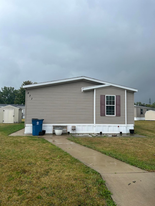 view of home's exterior featuring a shed and a yard