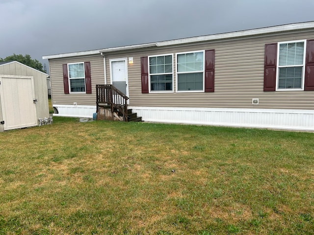 view of front facade with a front yard and a storage shed