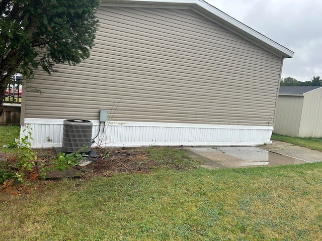 view of property exterior featuring a lawn and central AC