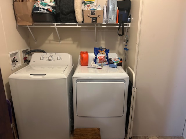 clothes washing area featuring washer and clothes dryer