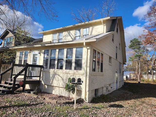 back of house featuring a sunroom