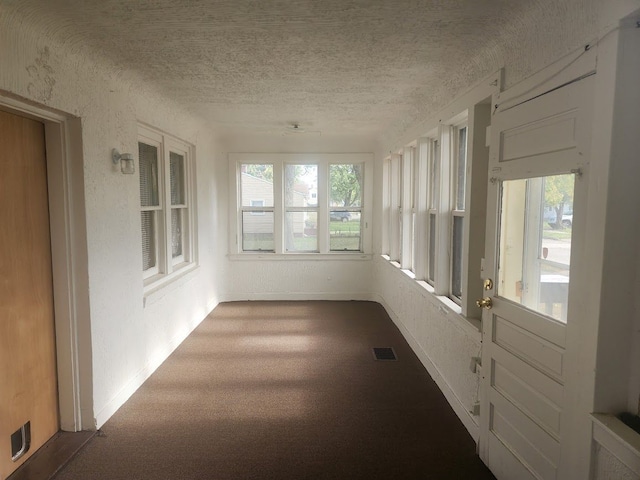 unfurnished sunroom with plenty of natural light