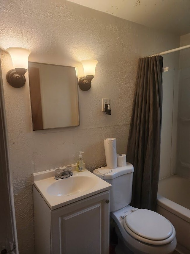 full bathroom featuring vanity, toilet, and shower / tub combo with curtain