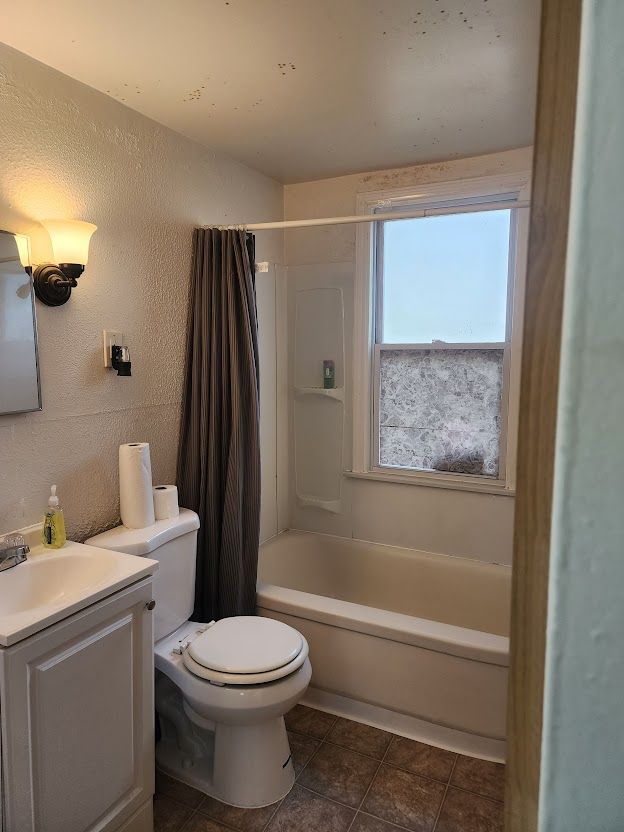 full bathroom with tile patterned flooring, vanity, toilet, and shower / tub combo with curtain