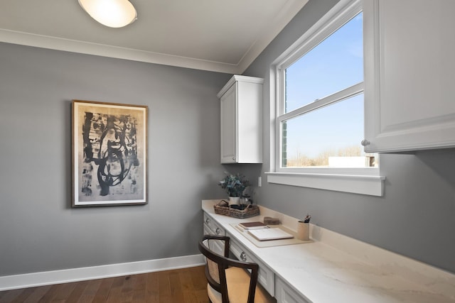 office with crown molding, dark hardwood / wood-style flooring, and built in desk