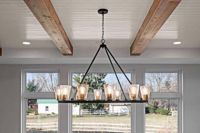 details featuring beamed ceiling and an inviting chandelier