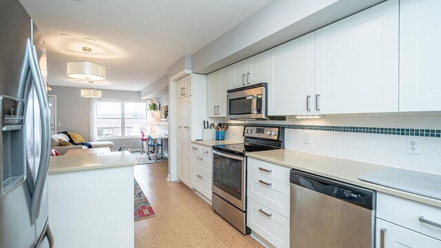 560 Little Lake Dr Unit 19, Ann Arbor, MI 48103 - kitchen featuring stainless steel appliances, backsplash, and white cabinets