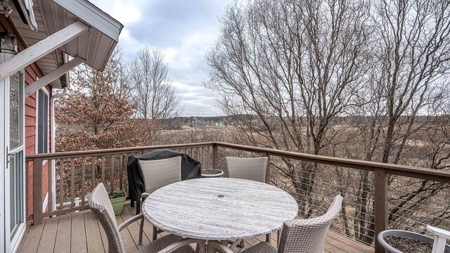 560 Little Lake Dr Unit 19, Ann Arbor, MI 48103 - view of wooden balcony with a wooden deck and outdoor dining area