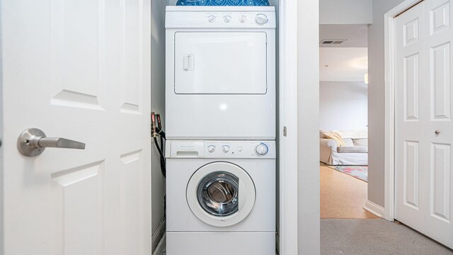 560 Little Lake Dr Unit 19, Ann Arbor, MI 48103 - washroom featuring stacked washer / drying machine and carpet flooring