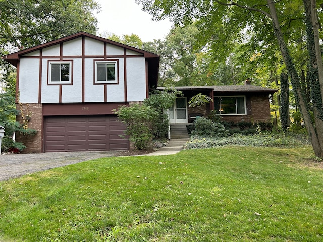 english style home featuring a garage and a front lawn