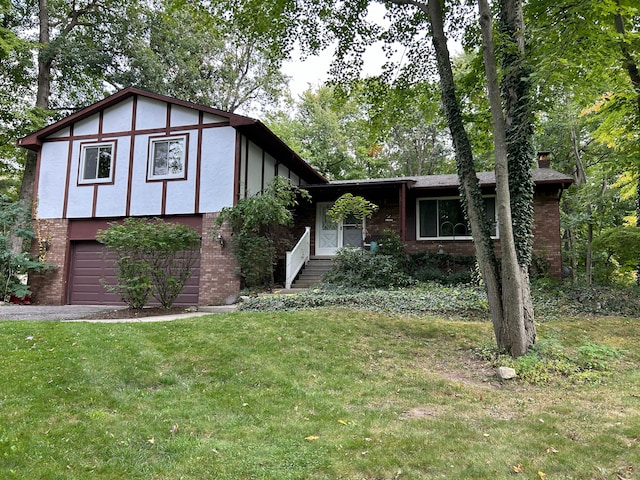 view of front of house featuring a garage and a front lawn