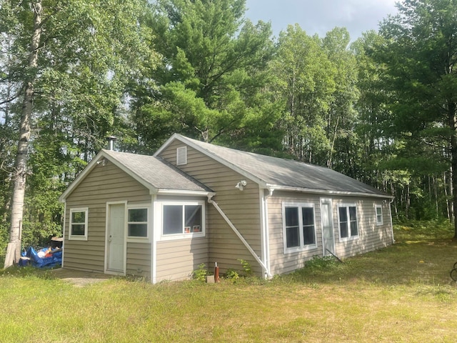 10544 N Lazy Ln, Bitely, MI 49309 - view of side of property with roof with shingles and a yard