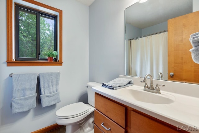 bathroom featuring vanity and toilet