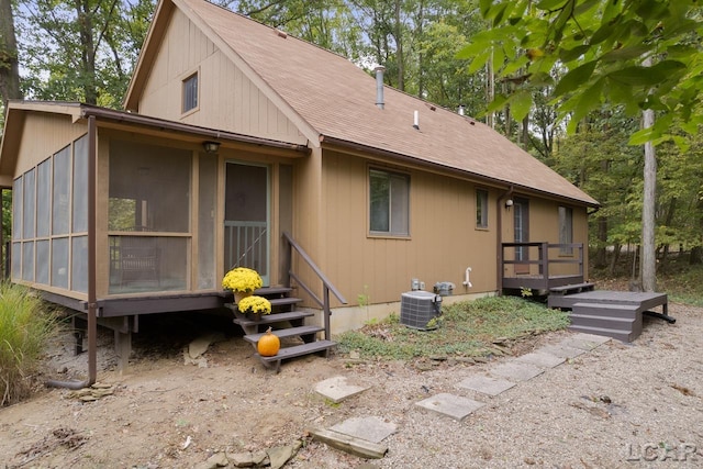 back of house featuring central AC and a sunroom