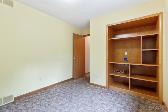 unfurnished bedroom featuring carpet flooring and a textured ceiling