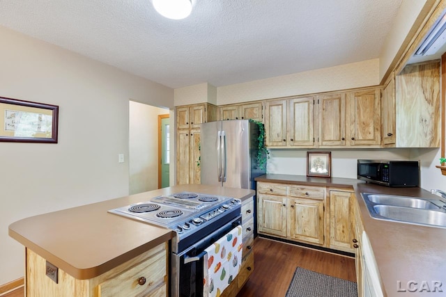 kitchen featuring appliances with stainless steel finishes, dark hardwood / wood-style flooring, a textured ceiling, and sink