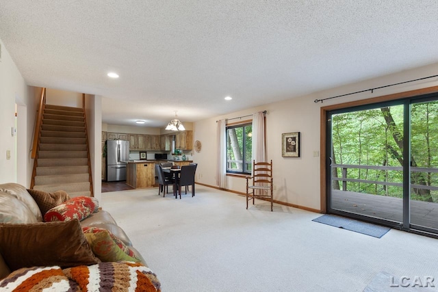 carpeted living room with a textured ceiling