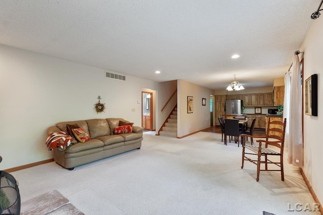 carpeted living room featuring a textured ceiling