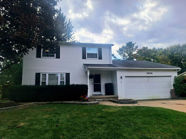 front of property with a front yard and a garage