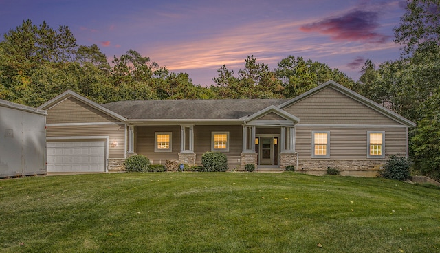 view of front of house with a yard and a garage